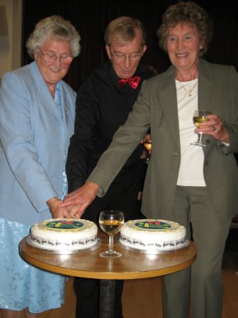Pat and Joan cut the 75th Anniversary cake, helped by MD Dennis Mason